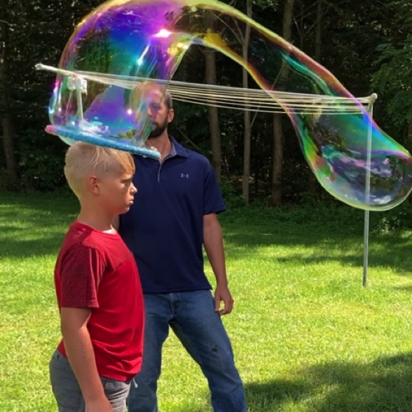 Boy's father giving his son a Mega Bubble Head!